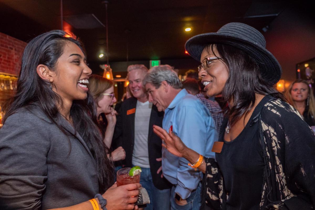Mentor and mentee have drinks at happy hour