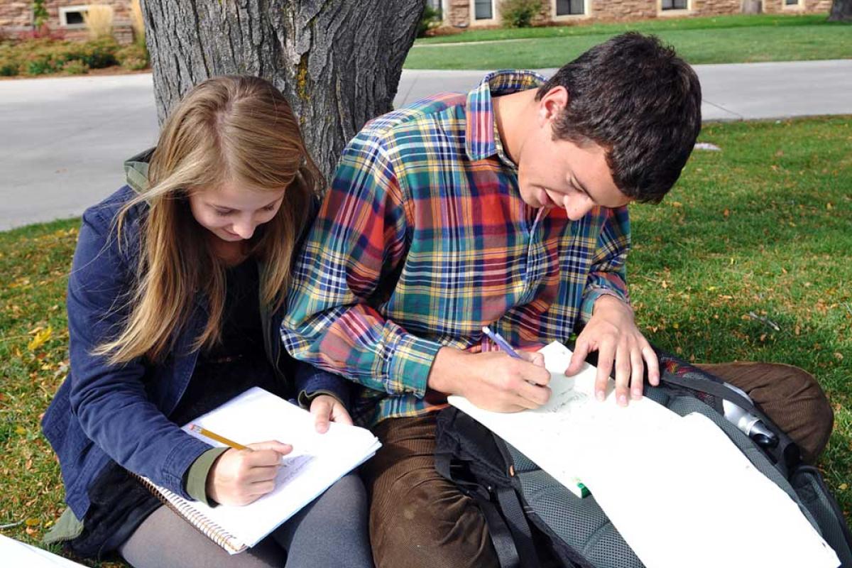 Students writing outdoors
