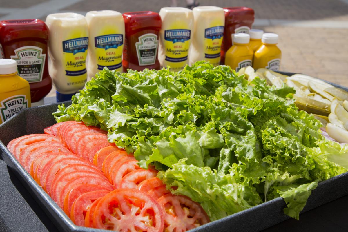platter with tomato, lettuce, pickles, ketchup and mustard