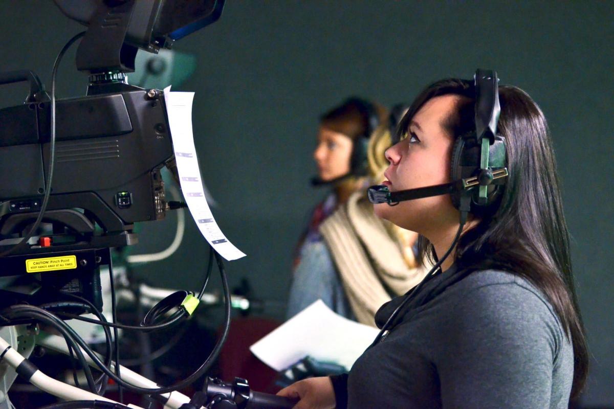 A student learning how to use a television broadcast camera